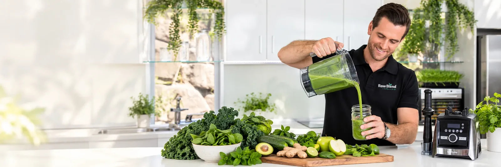 Smiling man pouring a green smoothie from a Vitamix blender in a bright kitchen