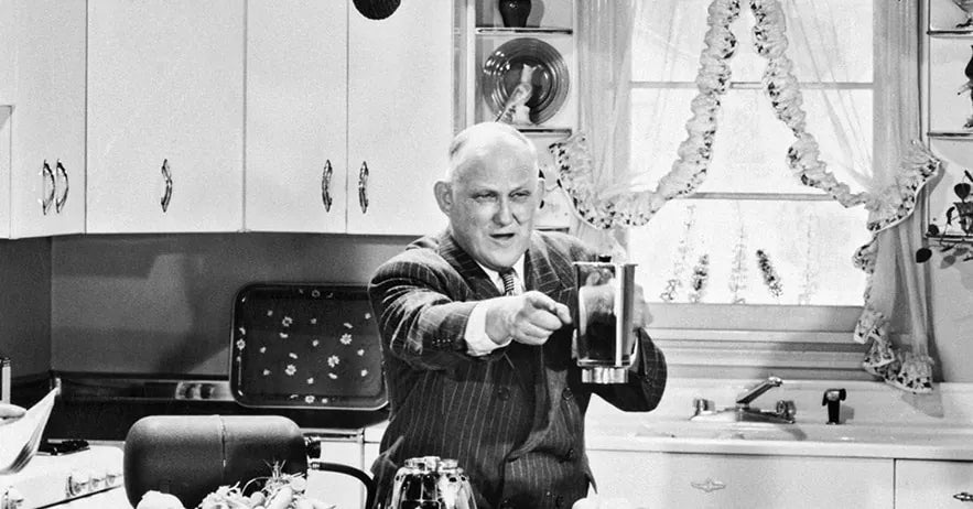 Papa Barnard demonstrating an early Vita-Mix in a 1940s kitchen