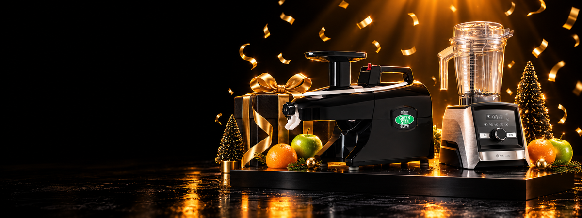 Black Friday Sale: a Greenstar Elite juicer and a Vitamix Ascent blender on a black stage with gold ribbons