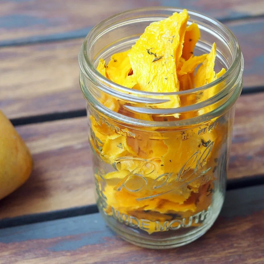 Dehydrated mango slices in a glass jar