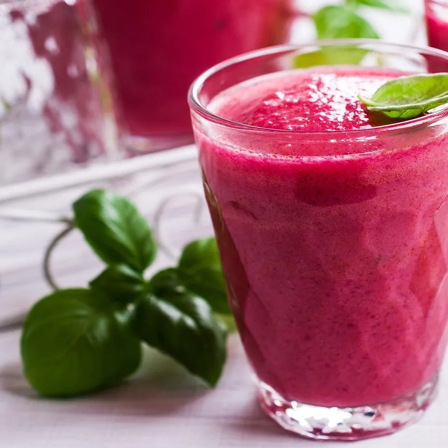 A bright pink spring smoothie with fresh basil