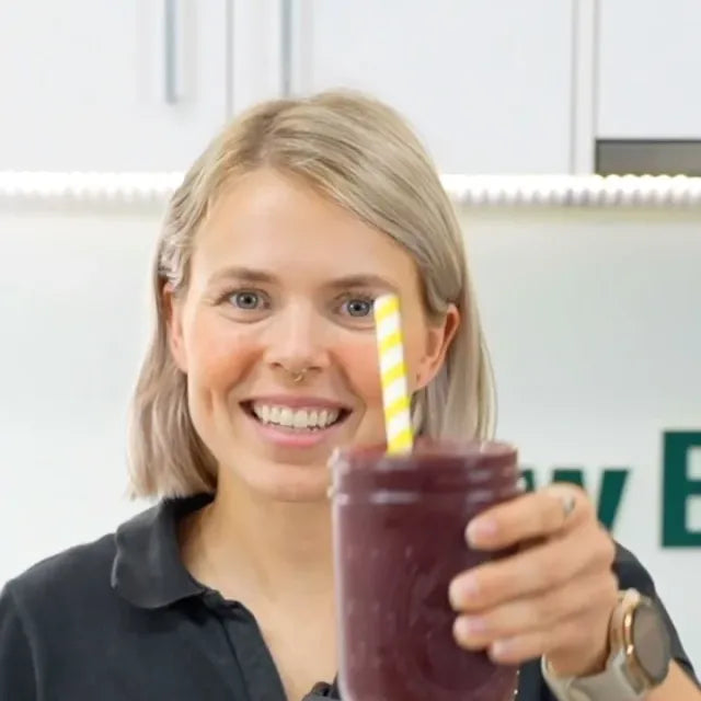 Raising a glass of minty blackberry smoothie