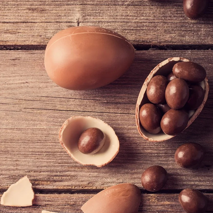 Raw chocolate creme eggs on a wooden board