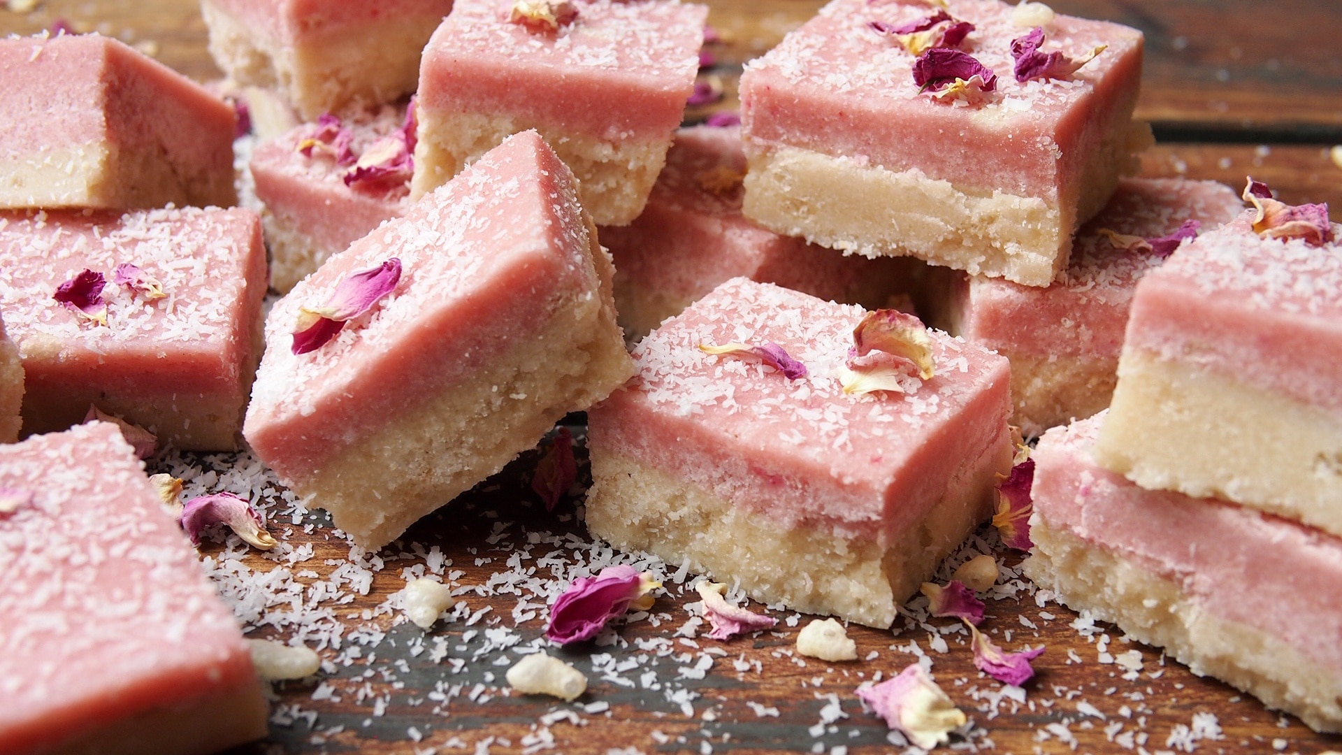 Photo of pink squared coconut slices with sprinkled coconut on top