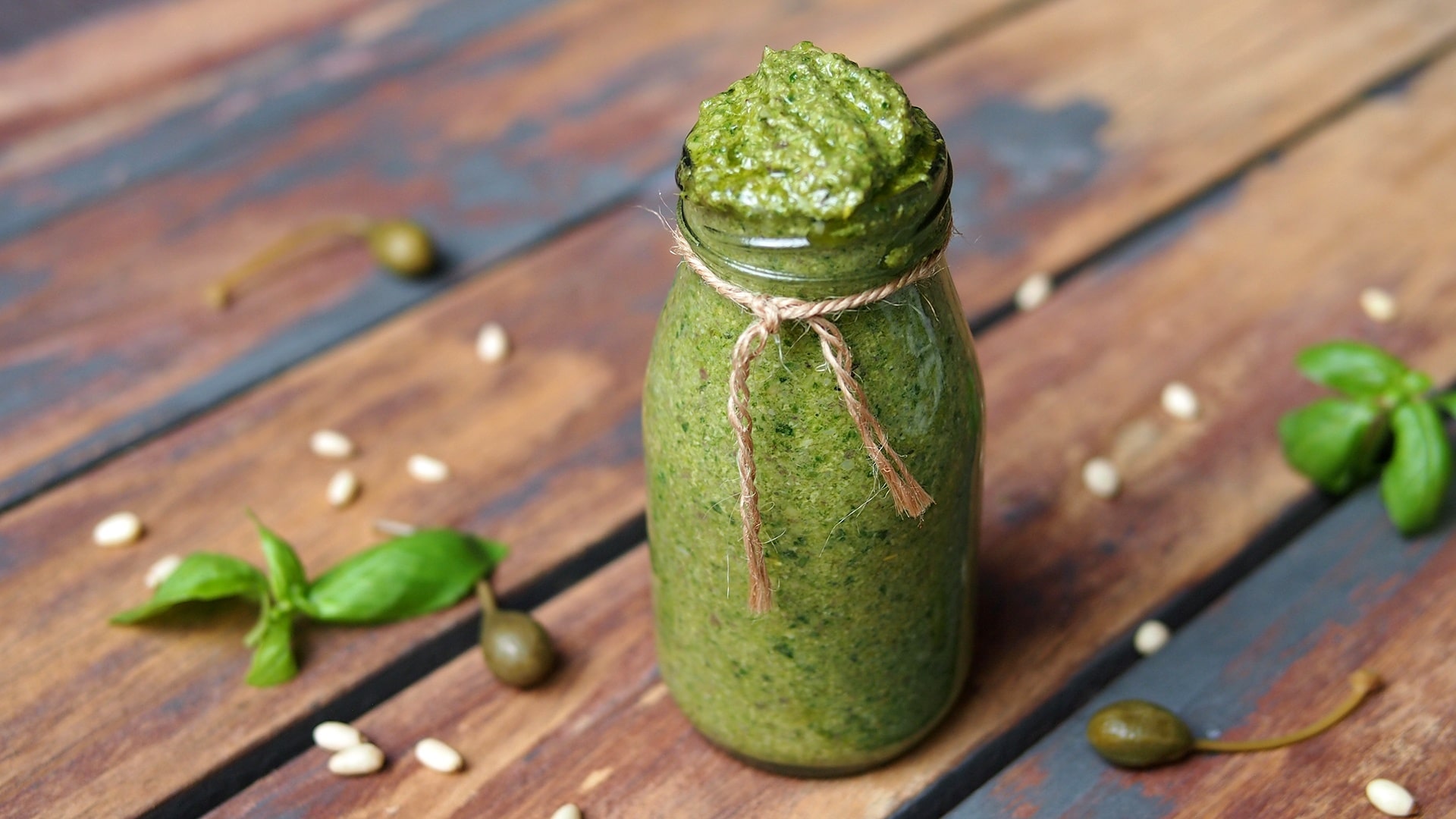 Picture of green vegan pesto in a glass jar
