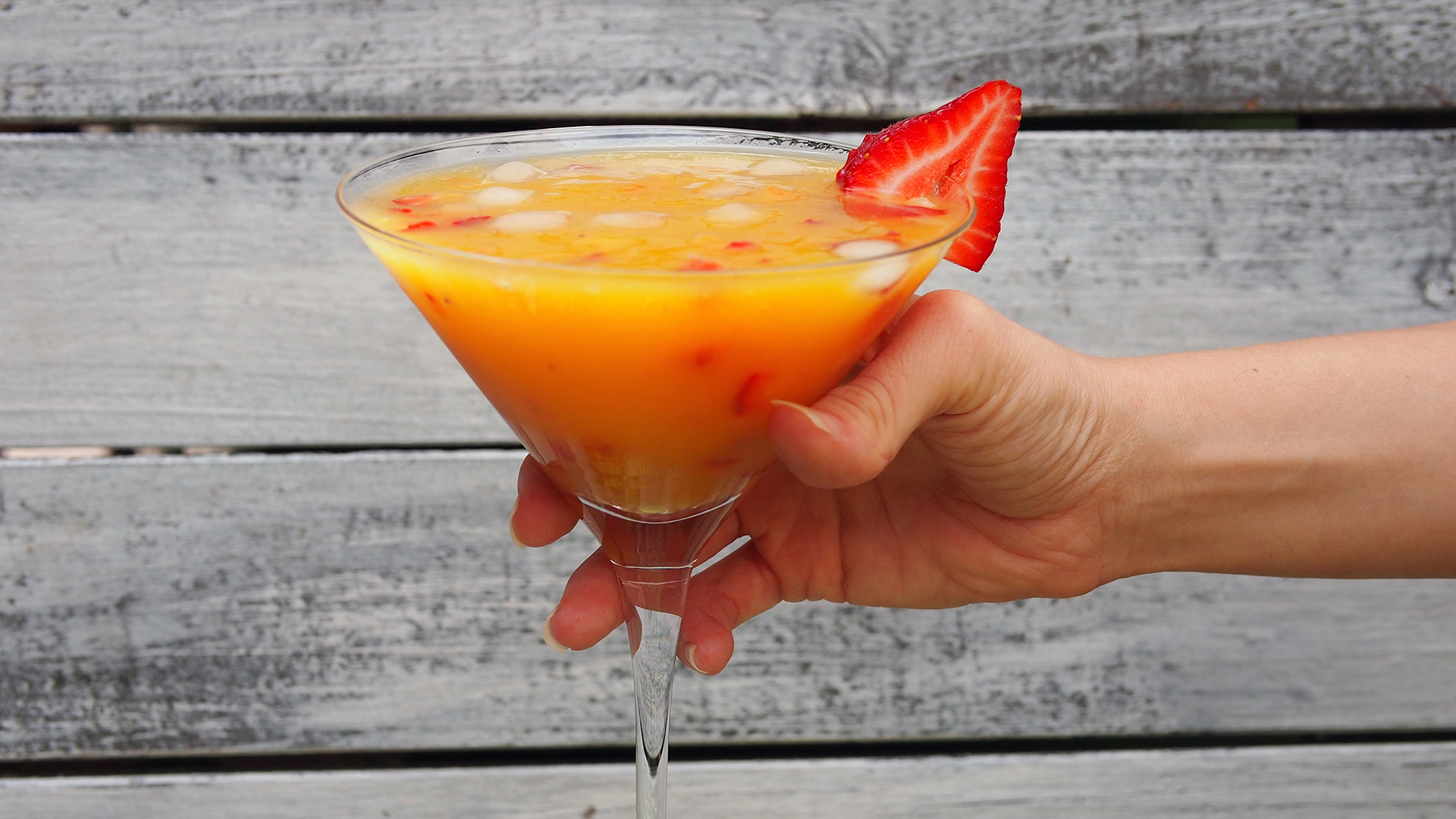 Image of a hand holding Summer Fruity Mocktail